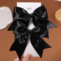 Set of two black satin bow hair clips for girls displayed on a white product card - 2 Pcs/Set / Black