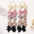 Detail view of 10-piece bow hair tie set in neutral tones on white background - Style 10E