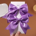 Pair of purple satin bow hair clips for girls displayed on a white card board - 2 Pcs/Set / Purple