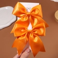Pair of bright orange satin bow hair clips for girls on a white display card - 2 Pcs/Set / Bright Orange