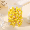 Pair of yellow daisy print grosgrain ribbon bow hair clips on display card - Yellow Daisy (FJ039-2A-15)