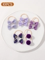 Set of 10 purple themed children's hair ties with bows and pom-poms on a white plate - Purple Pom-pom Plaid (set Of 10)