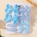 Set di 6 fermagli per capelli con fiocco in nastro azzurro per bambine su carta bianca - 8D