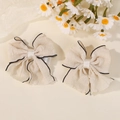 Set of two cream bow hair clips with elegant black wavy edge trim for girls - Beige with Black Edge