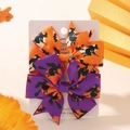 Macro detail of Halloween bow hair clips with witch prints on orange and purple grosgrain - Purple Orange Witch on Broom Style (2B)