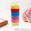 Elastic nylon hair ties in multiple vibrant colors and ribbed texture on a stand - Bright Multicolor (12H)