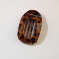 Detailed macro view of the glossy tortoiseshell resin finish on the oval hair clip - Oval Clip (Bulk) / Bright Dark Tortoise