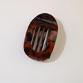 Detailed view of glossy leopard print hair clip with tortoiseshell pattern finish - Oval Clip (Bulk) / Glossy Red Tortoiseshell