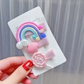 Close-up of cute rainbow and lollipop resin hair clips set for girls on display card - Pink