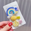 Detailed shot of cute rainbow and candy hair clips set for girls on a jewelry card - Yellow
