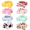 Detailed view of 8 coral fleece headbands in various patterns like leopard and polka dots - Style D