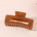 Detail view of translucent amber resin hair claw clip with YR-036 engraving - Bulk Packaging / Caramel color