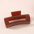Detail view of the amber brown rectangular hair claw clip with glossy finish - Reddish Brown