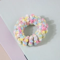 Macro shot of fluffy pastel plush hair tie with colorful soft pompom woven texture - Light Floral Mixed Color