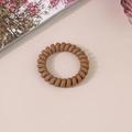 Close-up of a matte brown spiral hair tie with a flexible phone cord design for women - Matte Camel