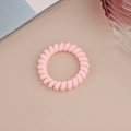 Detail of light pink spiral hair tie with a matte frosted texture on a flat lay background - Matte Light Pink