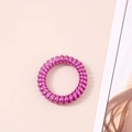 Close-up of metallic magenta spiral hair tie with elastic phone cord design - Metallic Rose Red