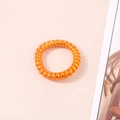 Close-up of orange metallic spiral hair tie with high elasticity for ponytails - Metallic Orange