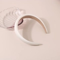 Detail of white padded satin headband featuring non-slip lining and thick sponge design - Satin White
