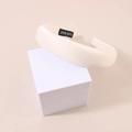 Detail of white satin sponge headband showing the handmade label on interior - Padded Satin - Milk White