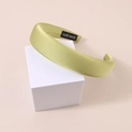 Close-up of handmade avocado green satin headband with thick sponge padded texture - Padded Satin - Olive Green