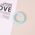 Elastic sky blue spiral telephone cord hair tie for ponytail styling on a decorative card - Glossy Light Blue