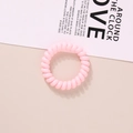 Elastic pink spiral hair tie with a telephone wire design for a stylish ponytail - Glossy Light Pink