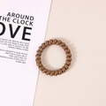 Elastic brown spiral hair coil phone cord hair tie on a minimalist background - Glossy Brown
