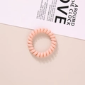 Elastic light pink spiral hair tie made of durable resin on a minimalist background - Glossy Lotus Pink