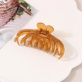 Detail of a large amber hair claw clip with heart-shaped handle on a white tray - Individual Packaging / Jelly Brown