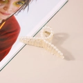 Detail shot of the cream resin hair claw with inlaid white pearls on a minimalist background - 11cm Ribbon Style - Cream White