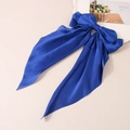 Elegant royal blue satin bow hair clip with long streamers on minimalist beige background - Sapphire Blue