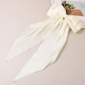 Elegant cream white satin bow hair clip with long ribbons on a minimalist background - Milk White