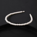 Detailed shot of white pearl headband featuring round beads on a slim metal base - Uniform Pearl Single Loop Style