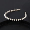 Elegant gold metal headband with white faux pearls featuring a minimalist vintage woven design - Cross Woven Pearl Style