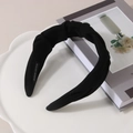 Detail view of black knotted wide headband showing the Hand Made label on fabric texture - Black