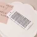 Set of black wave textured seamless metal hairpins on a white display card - Style E