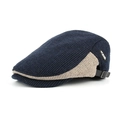 Detail of navy knit cap showing contrast stripes, side letter patch and metal adjustment buckle - Navy Blue