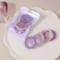 Purple spiral hair ties set with polka dots and star patterns in a frosted pouch - Purple Series