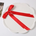 Elegant bright red double-layer satin bow hair clip placed on a white ceramic plate - Red