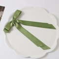 Green polyester cotton double-layered bow hair clip with long ribbons on white plate - Green