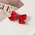 Classic red satin bow hair clip with glossy texture and black metal duckbill base - Red
