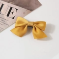 Elegant golden satin bow hair clip for children with smooth polyester ribbon finish - Yellow