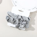 Two-piece silver gray satin scrunchie set on a white card with smooth glossy finish - Aquamarine