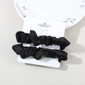 Two-pack black satin scrunchies with elastic pleats displayed on a white card - Black