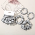 Five-pack of silver grey satin hair scrunchies on a decorative shell-shaped glass plate - Aquamarine