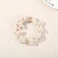 Cream mesh scrunchie with lace edges and faux pearls on a beige background - Pearl White - Lace Style