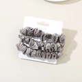 Three-piece set of silver-grey pleated silk hair scrunchies on a white display card - Dark Gray