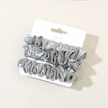 Three-piece set of silver grey silk satin scrunchies displayed on white card packaging - Aquamarine