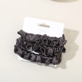 Three-pack of dark brown elastic satin scrunchies displayed on a white card with a bow - Dark Purple